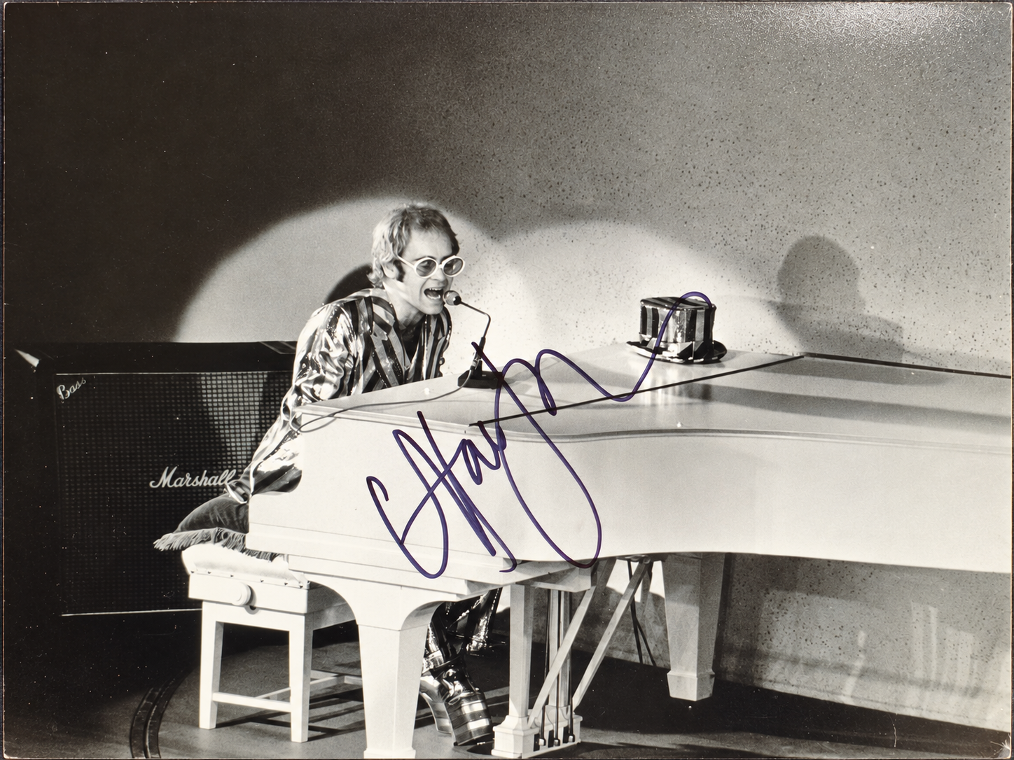 Elton John signed 8×10 black-and-white concert photo at a white piano, authenticated by Beckett BAS.